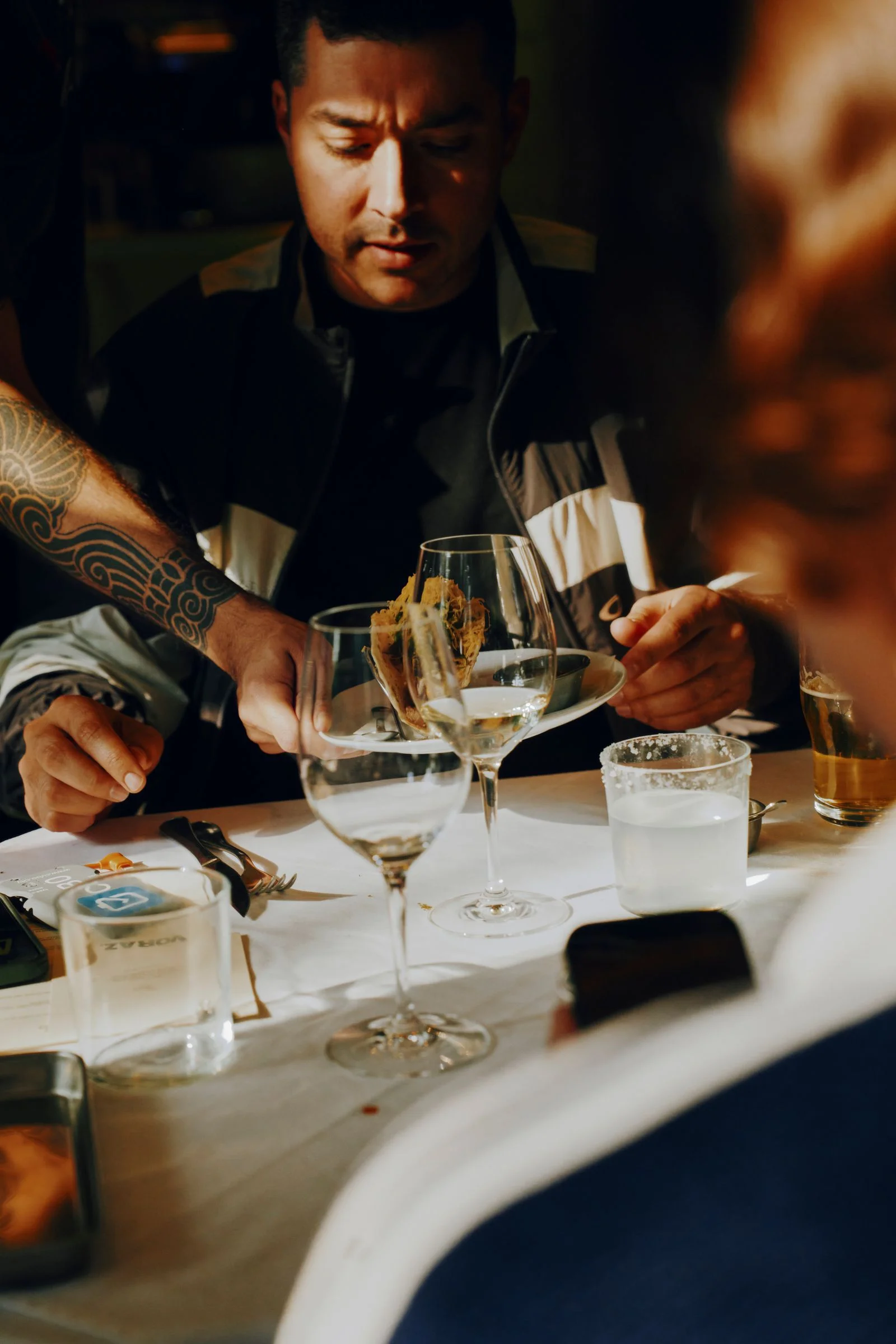 Image may contain Wine Glass Dining Table Furniture Table Adult Person Face and Head