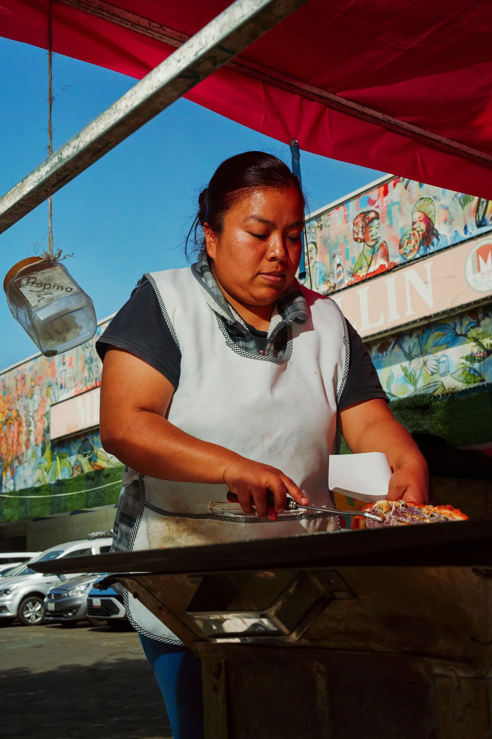 Image may contain Adult Person Machine Wheel Face Head Cooking Gorditas Market and Comal