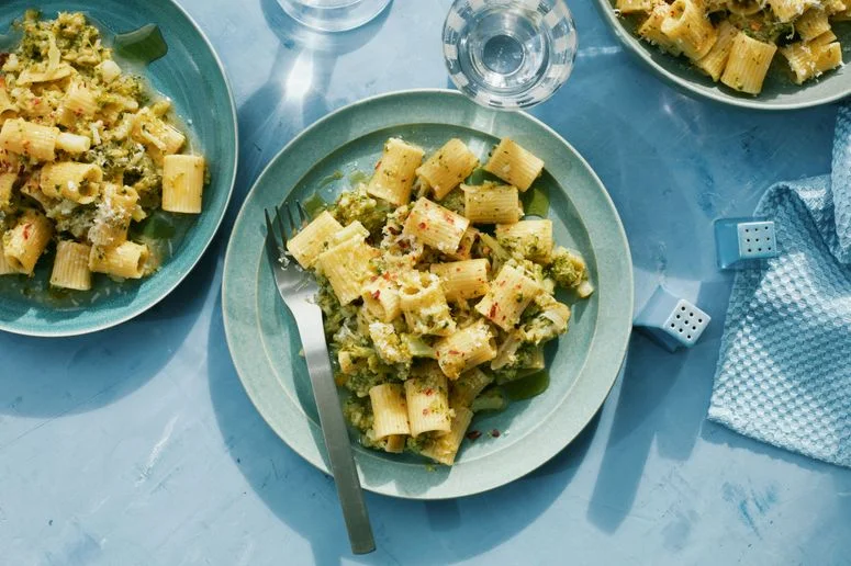 Three bowls of mezze rigatoni tossed broccoli stems in a lemonyanchovy sauce.