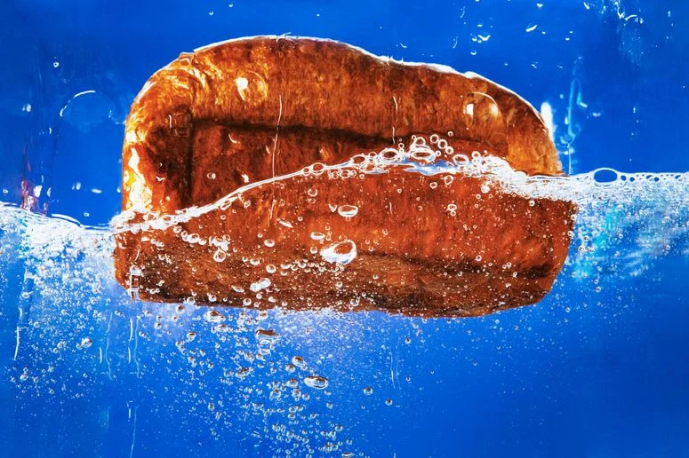 A loaf of bread in water, demonstrating how to revive stale bread.