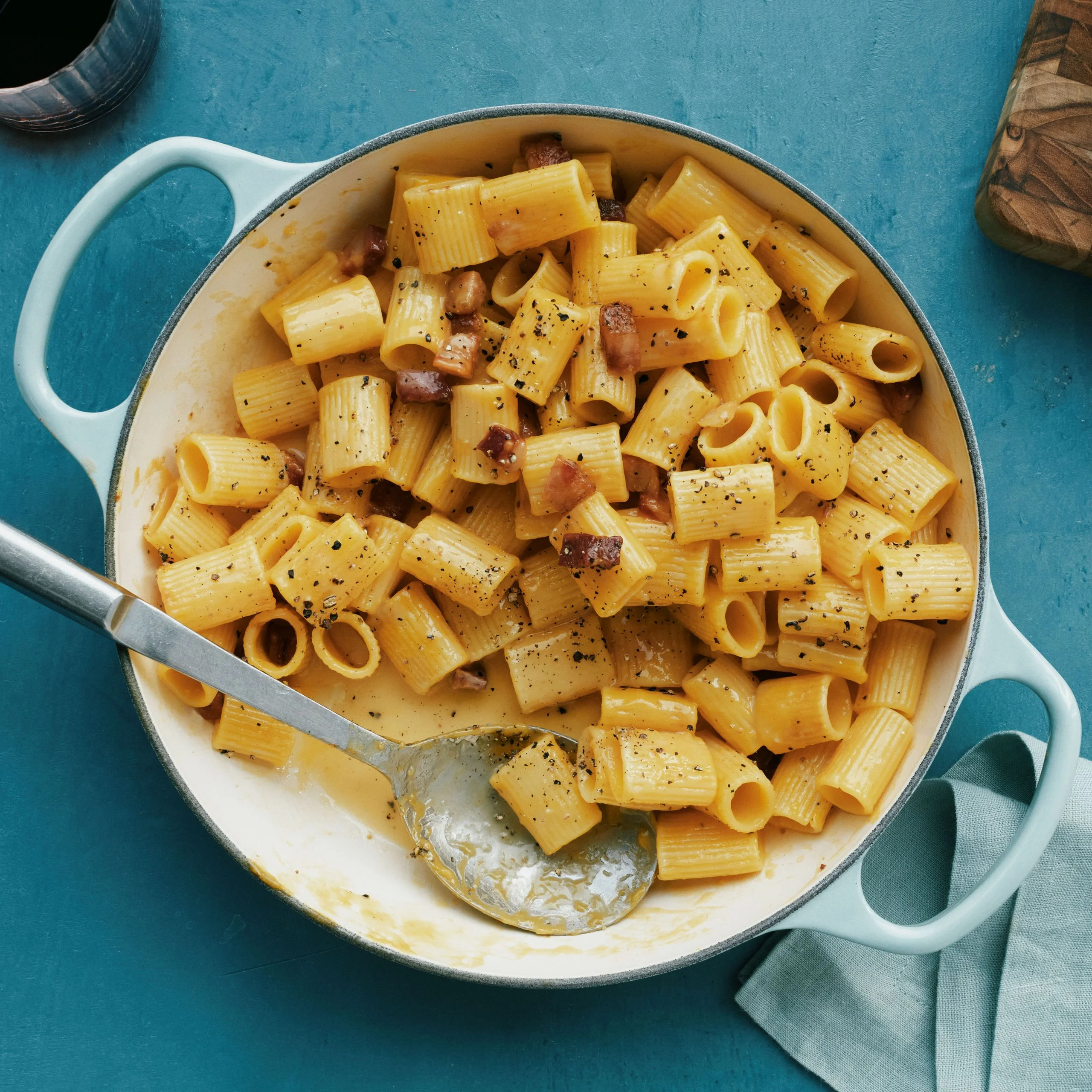 A big pot of pancetta carbonara with mezze rigatoni with a creamy sauce.