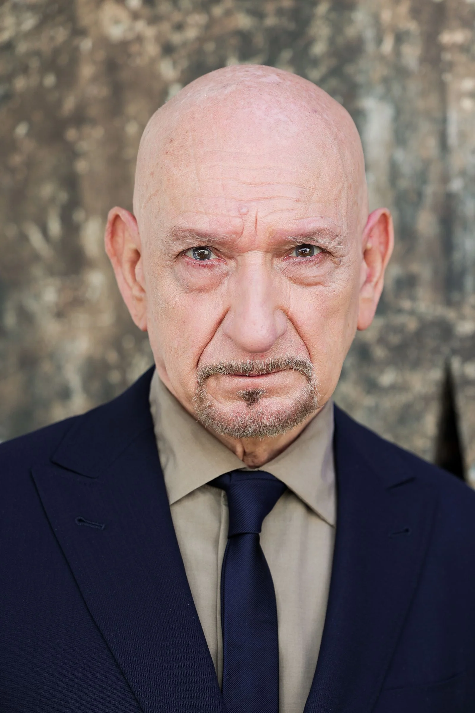 Image may contain Ben Kingsley Face Frown Head Person Sad Photography Portrait Accessories Formal Wear and Tie