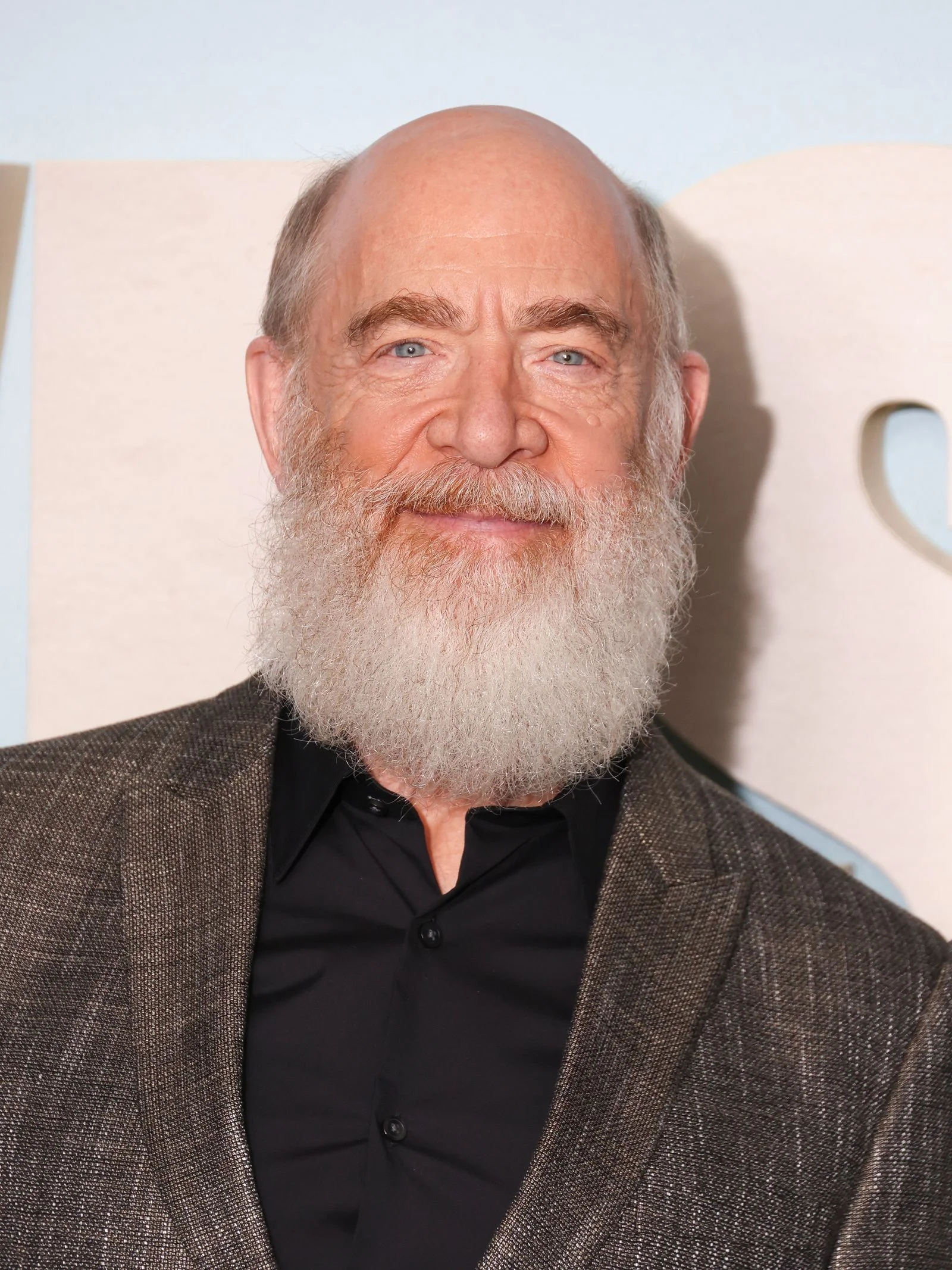 Image may contain J. K. Simmons Beard Face Head Person Adult Clothing Coat Photography and Portrait