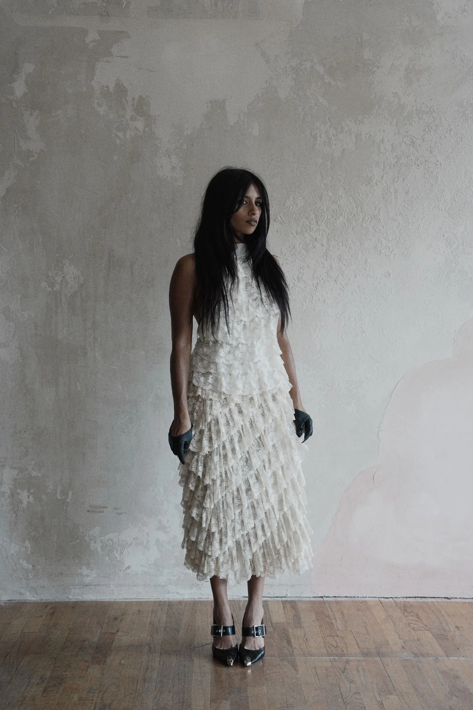 Image may contain Clothing Sleeve Black Hair Hair Person Adult Glove Standing and Dress