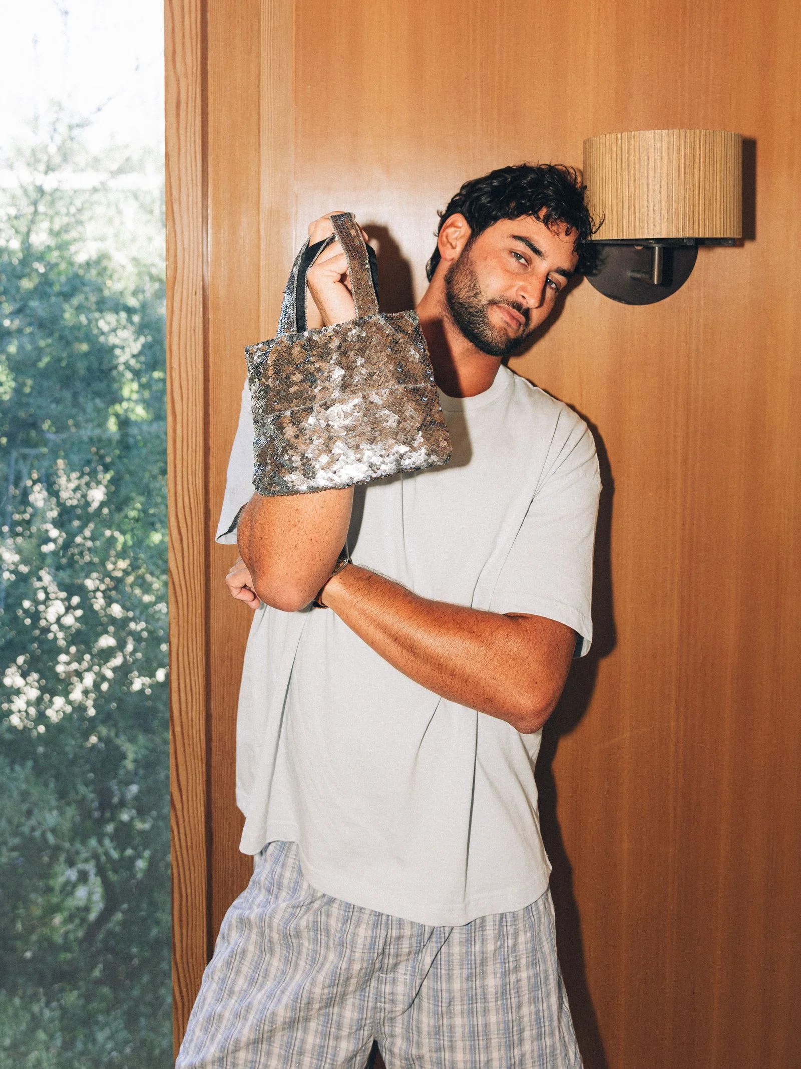 Image may contain Adult Person Head Face Accessories Bag Handbag Clothing Sleeve Lamp Photography and Portrait