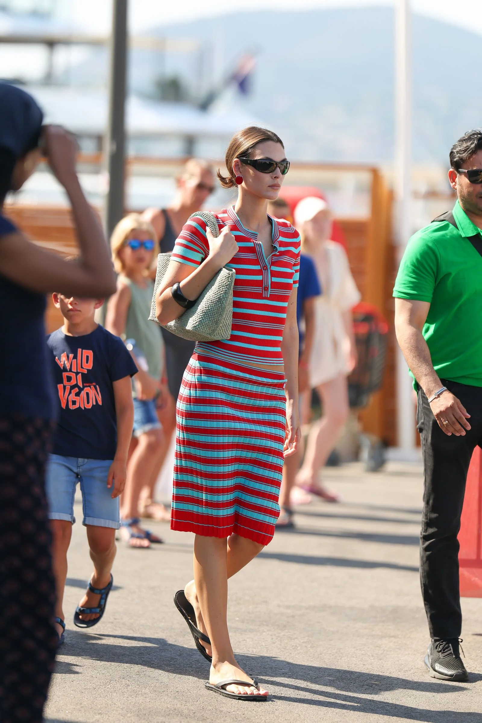 Image may contain Person Walking Child Adult Accessories Bag Handbag Clothing Shorts Face Head and Skirt