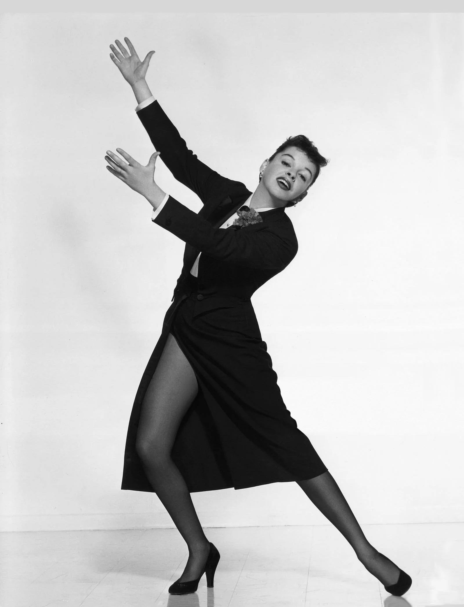 Image may contain Judy Garland Dancing Leisure Activities Person Adult Clothing Coat Face and Head