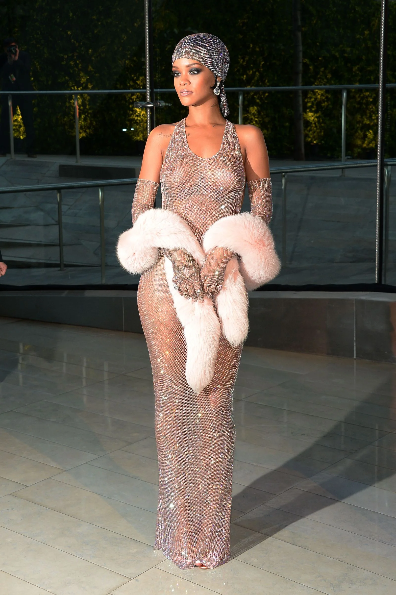 Image may contain Rihanna Person Adult Clothing Dress Formal Wear Face Head Photography Portrait and Standing