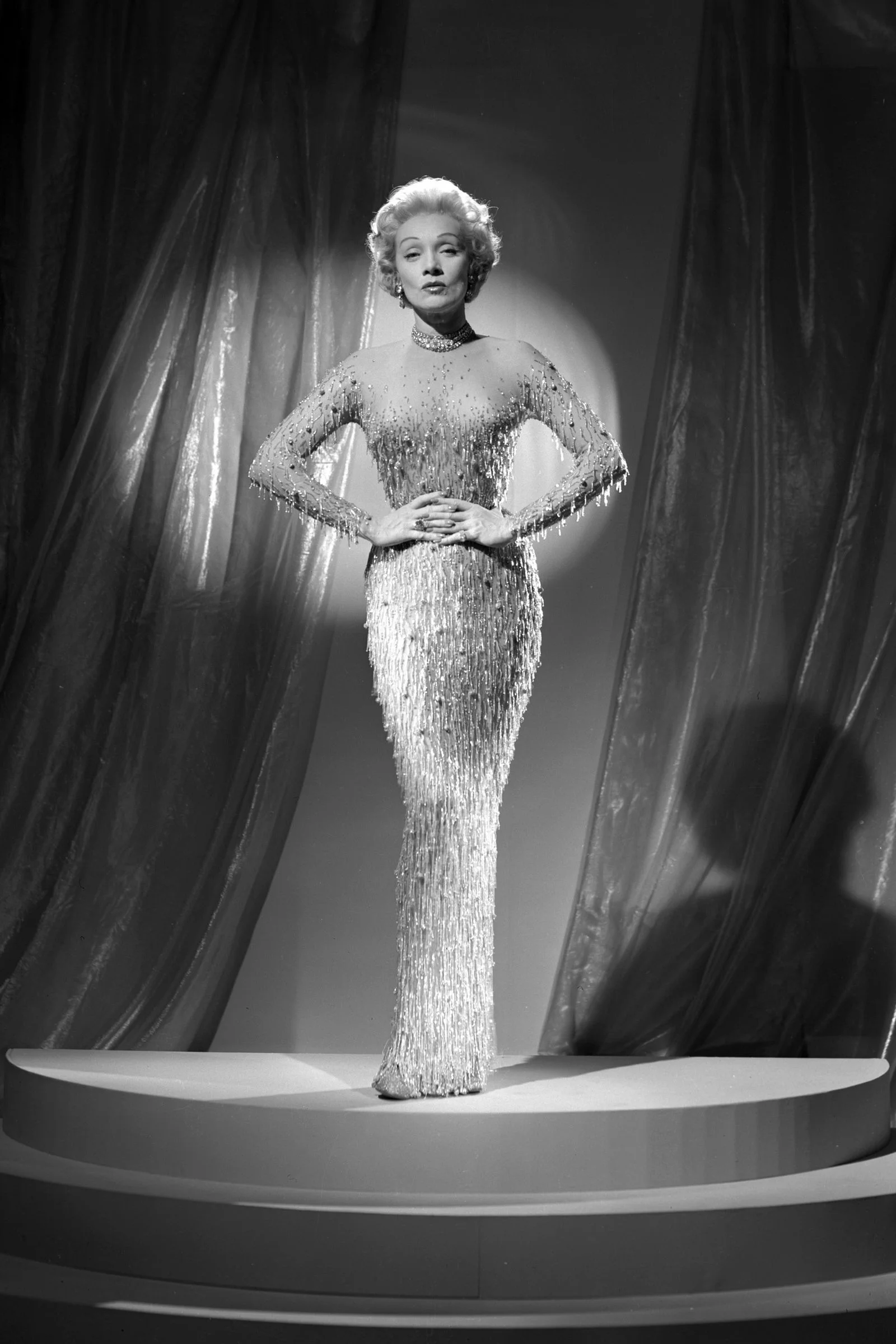 Image may contain Marlene Dietrich Person Adult Wedding Clothing Dress Formal Wear Accessories Jewelry and Necklace