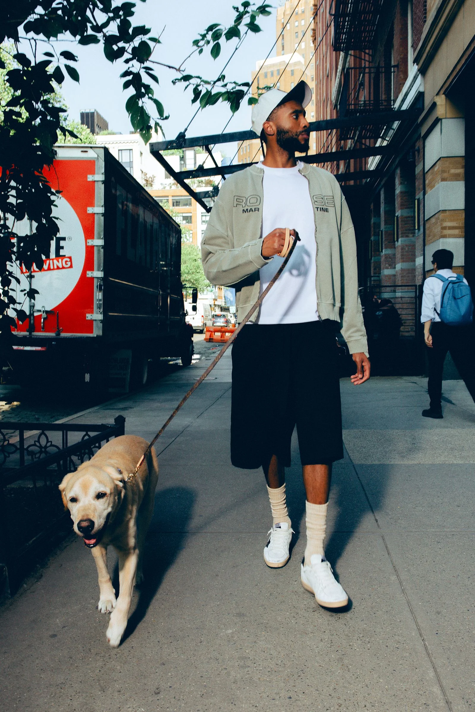 Image may contain Mikal Bridges Transportation Truck Vehicle Person Teen Adult Animal Canine Dog Mammal and Pet