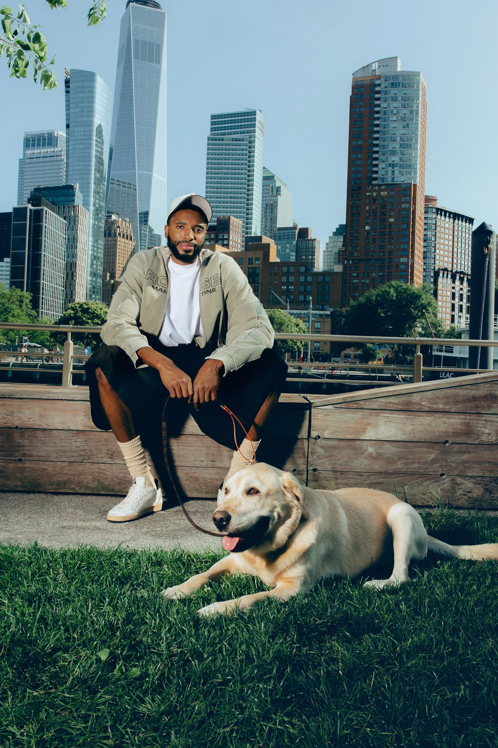 Image may contain Mikal Bridges City Person Sitting Adult Animal Canine Dog Mammal Pet Urban and Architecture