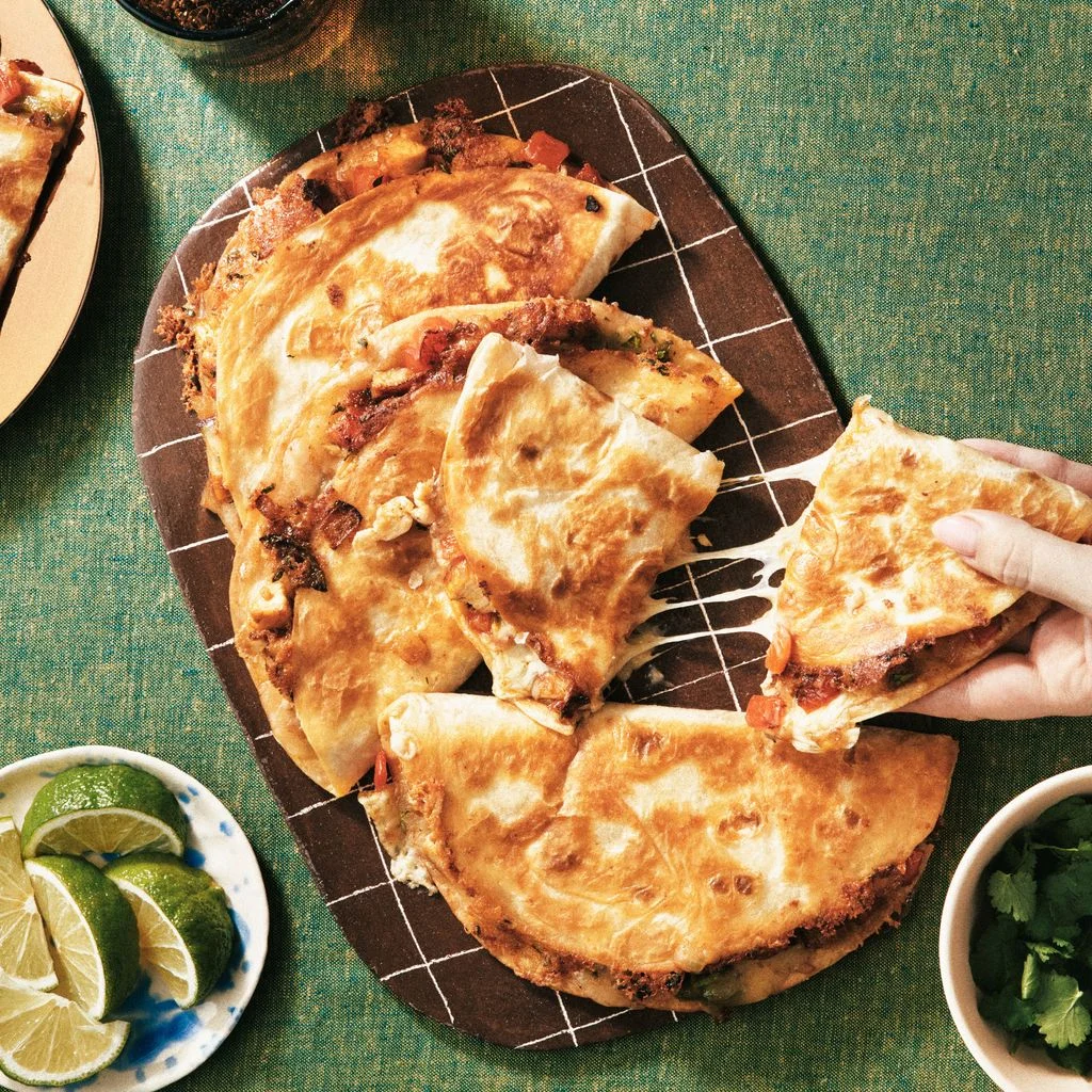 Five quesadillas filled with diced chicken shredded pepper Jack cheese red bell peppers yellow onions and served with...