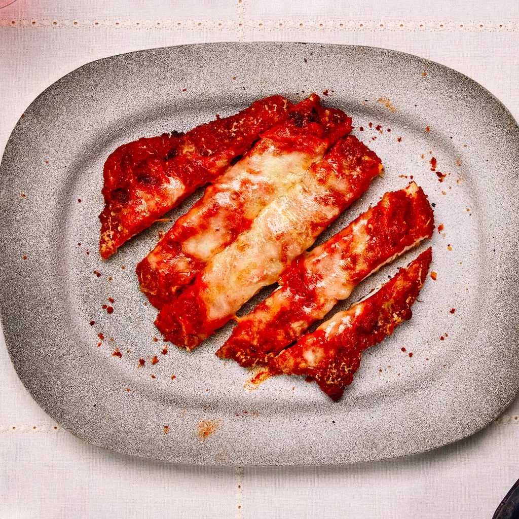 Buldak Chicken Parm on a silver plate.