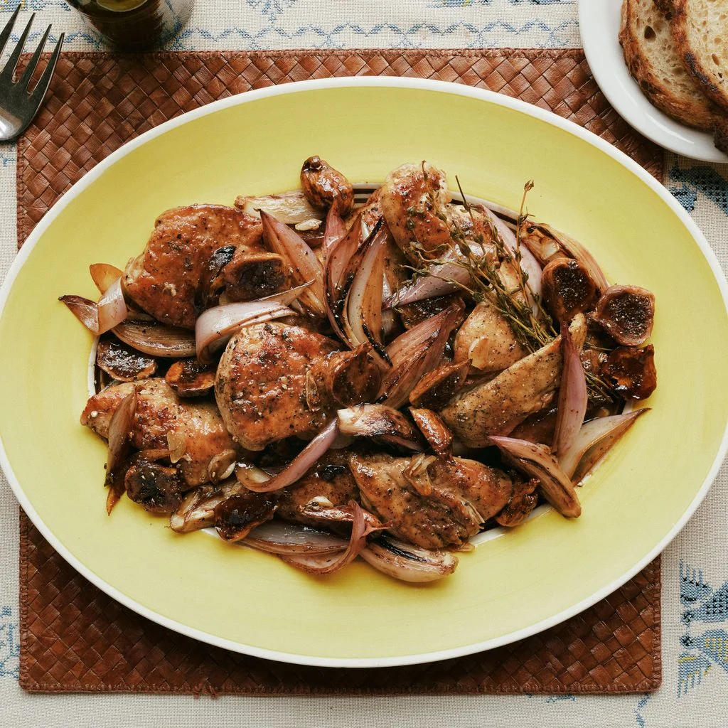 Chicken thighs cooked in black vinegar with shallots thyme and figs served with bread.