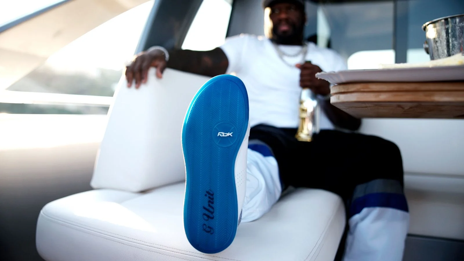 Image may contain 50 Cent Clothing Footwear Shoe Sneaker Adult Person Body Part Finger Hand Face and Head