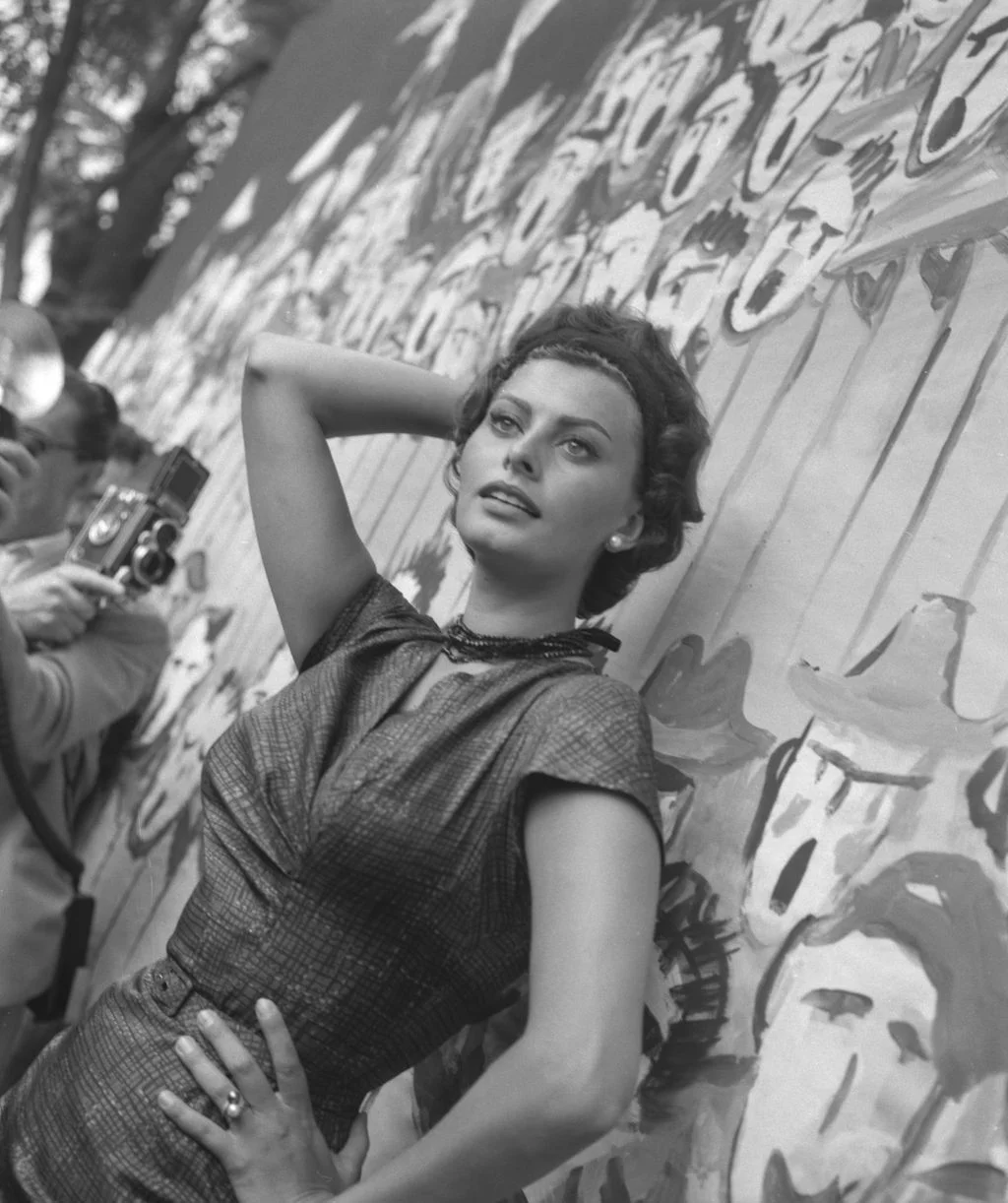 Image may contain Sophia Loren Photography Face Head Person Portrait Body Part Finger Hand Adult and Photographer