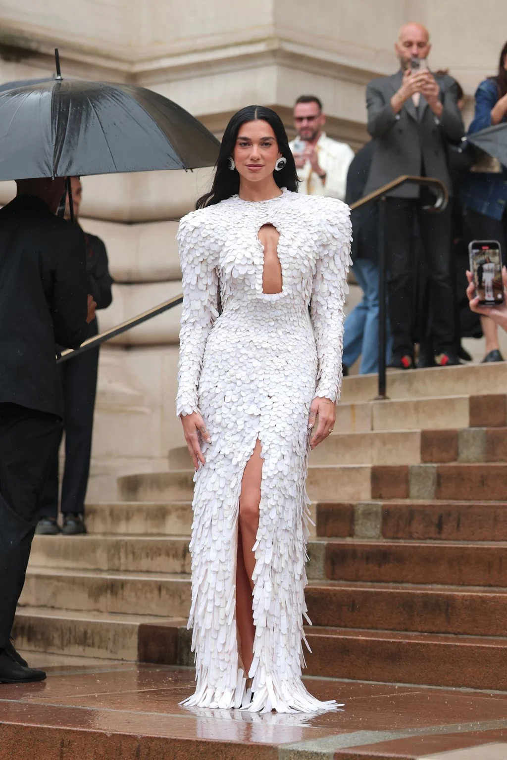 Image may contain Dua Lipa Person Electronics Mobile Phone Phone Clothing Footwear Shoe Adult Wedding and Head