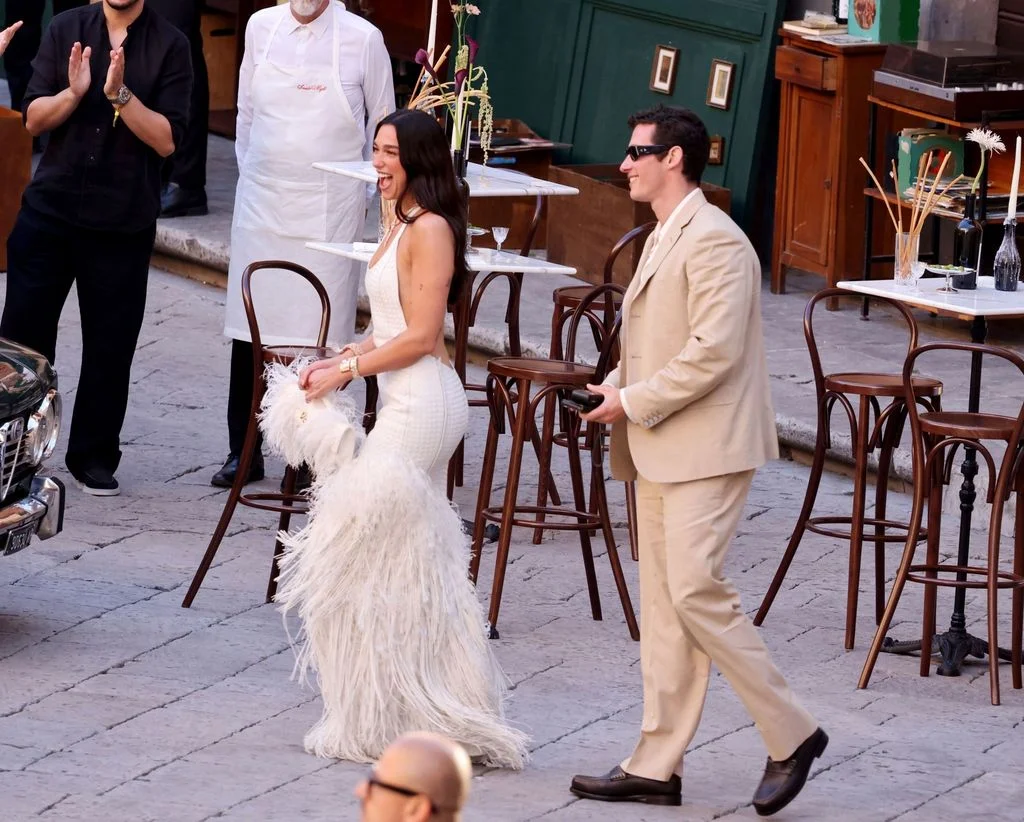Image may contain Callum Turner Dua Lipa Clothing Footwear Shoe Adult Person Wedding Accessories Glasses and Coat