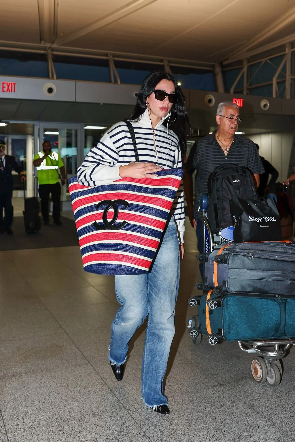 Image may contain Dua Lipa Işık Koşaner Clothing Pants Person Adult Accessories Bag Handbag Airport and Jewelry