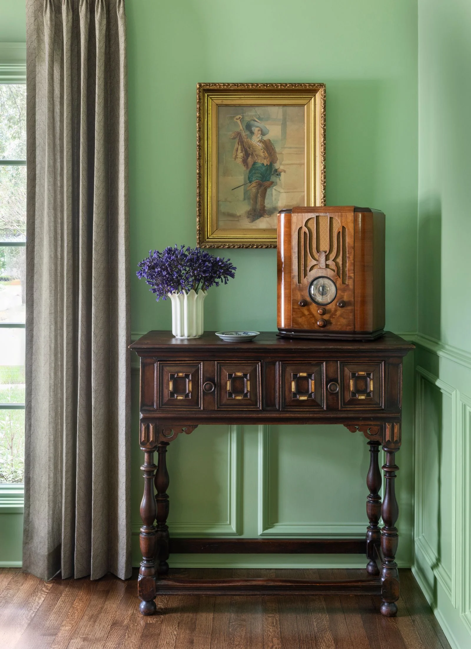 Image may contain Corner Furniture Table Art Painting Desk Person Sideboard Indoors Interior Design and Plant