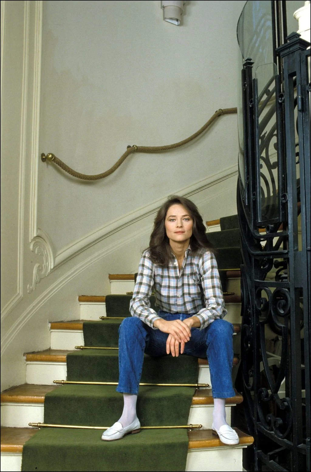 Image may contain Charlotte Rampling Architecture Building House Housing Staircase Person Sitting and Clothing