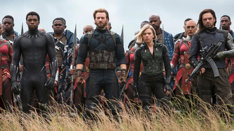 Chris Evans as Steve Rogers/Captain America, Sebastian Stan as Bucky Barnes, Chadwick Boseman as T'Challa / Black Panther, Scarlett Johansson as Natasha Romanoff / Black Widow ready to fight in Avengers: Infinity War