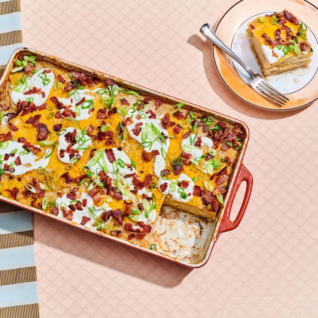 Loaded scalloped potatoes in a red baking dish