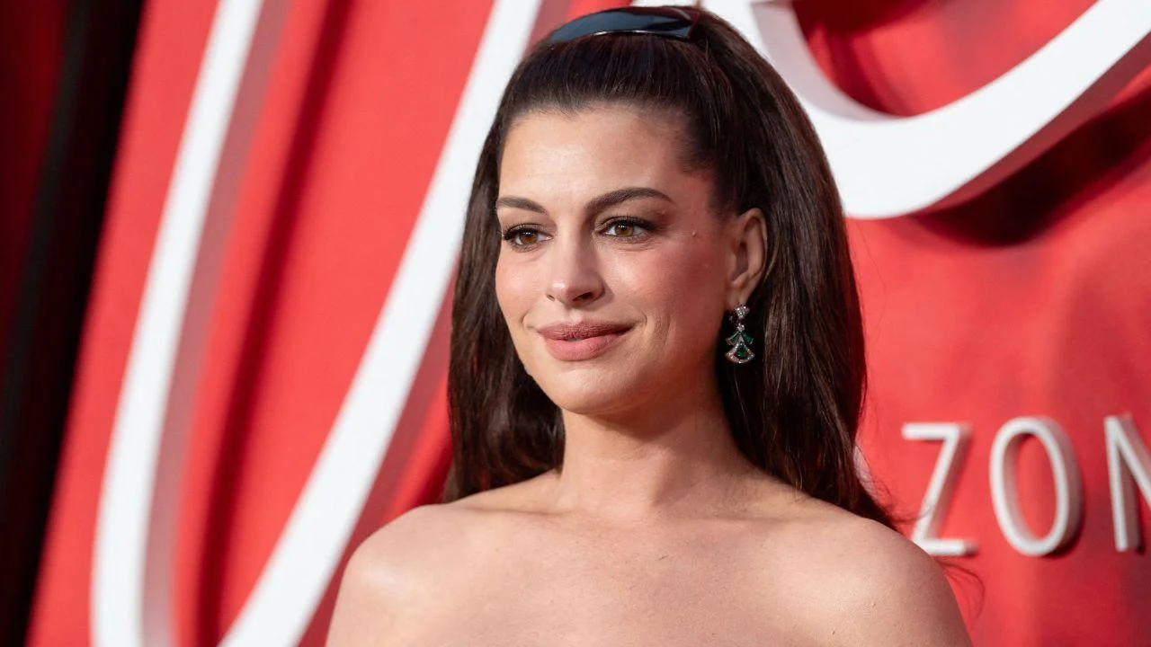 Image of Anne Hathaway poked fun at herself for taking charge at the photo call.