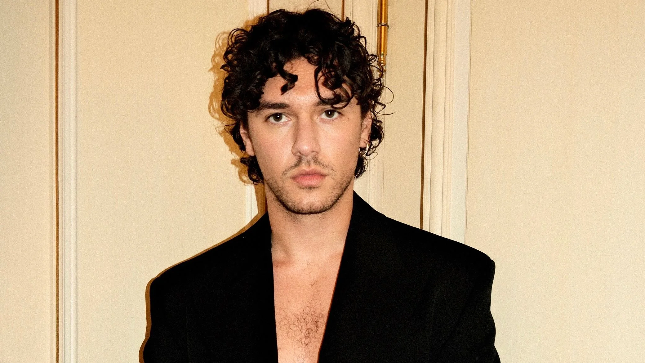 Image may contain belmont cameli belmont cameli curly hair Clothing Formal Wear Suit Blazer Coat Jacket Adult Person...