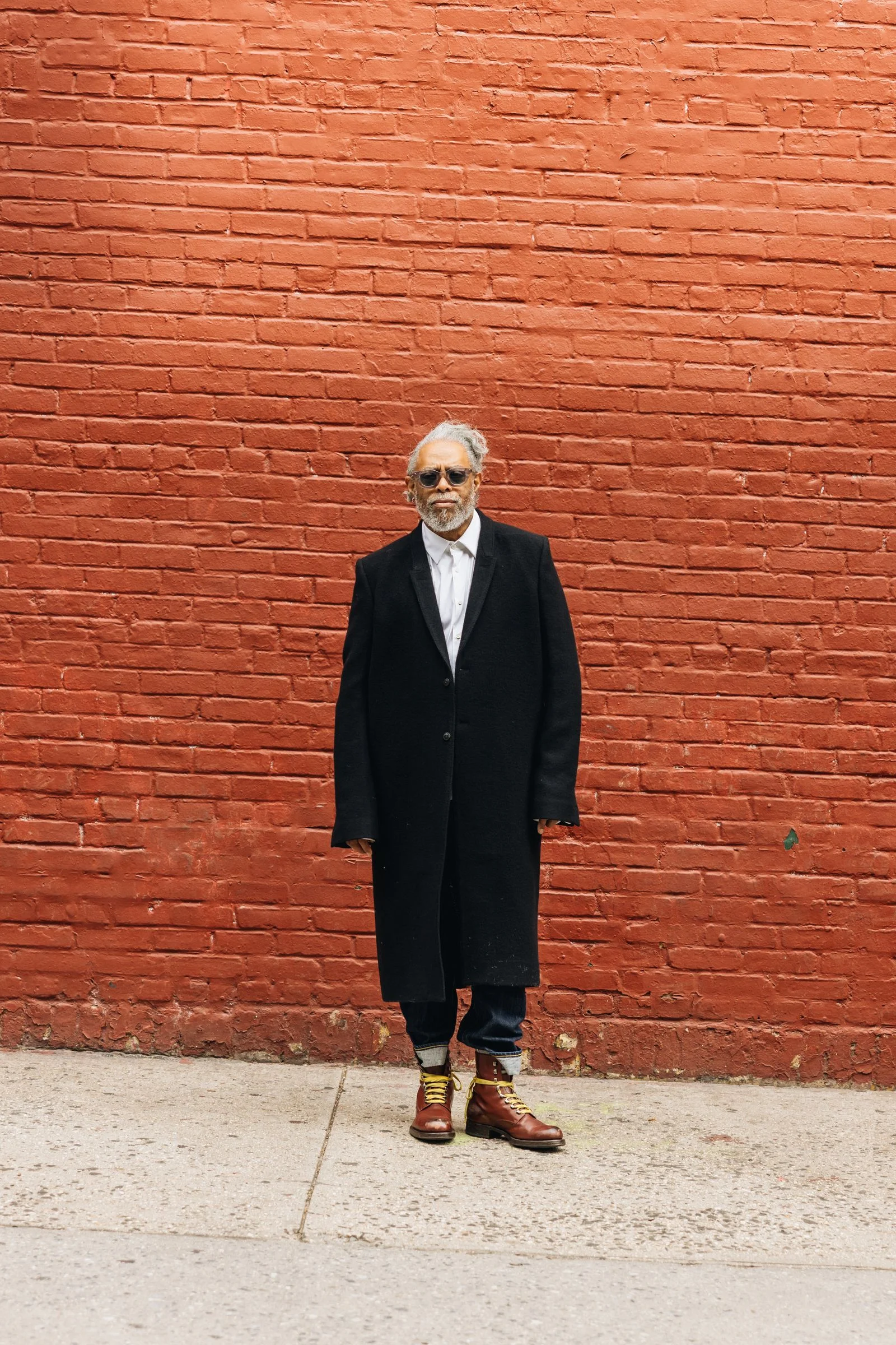 Image may contain Coolio Person Standing Clothing Coat Blazer Jacket Adult and Overcoat