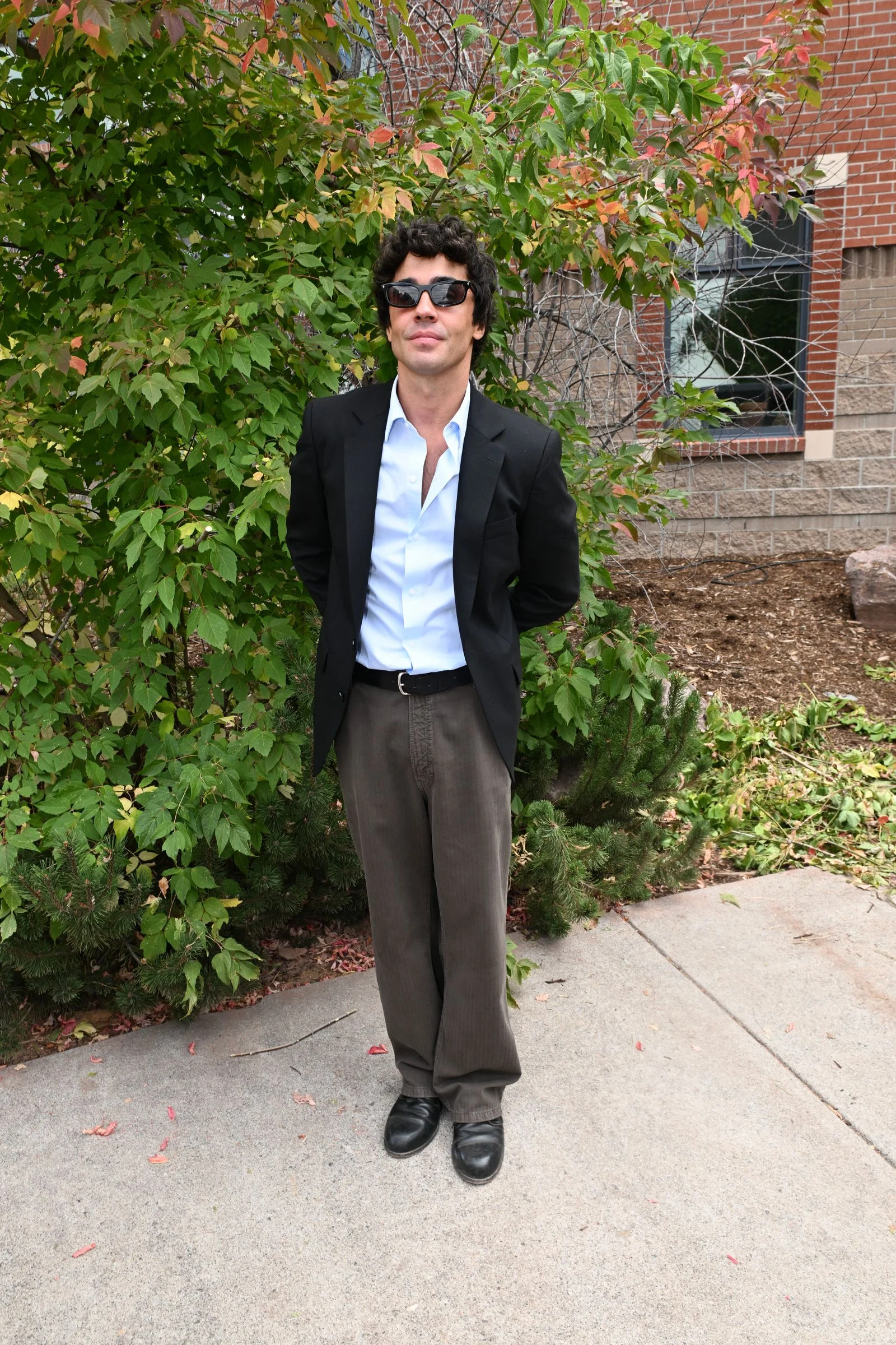 Image may contain Blazer Clothing Coat Jacket Formal Wear Suit Person Standing Face Head Photography and Portrait