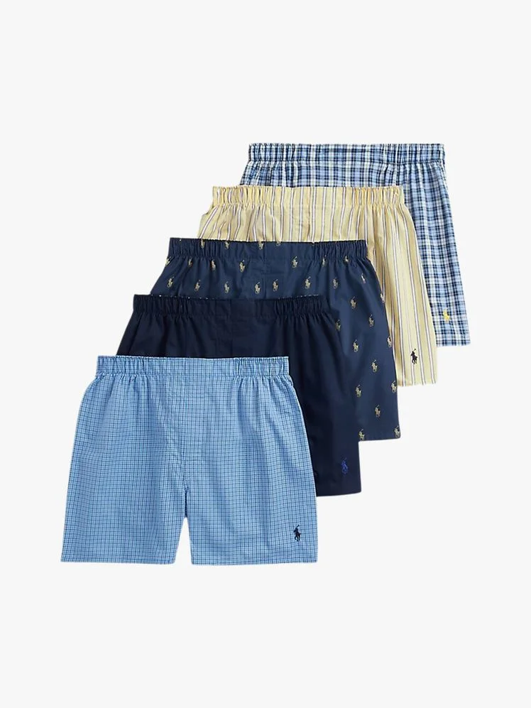 Five pairs of boxers on a flat background.