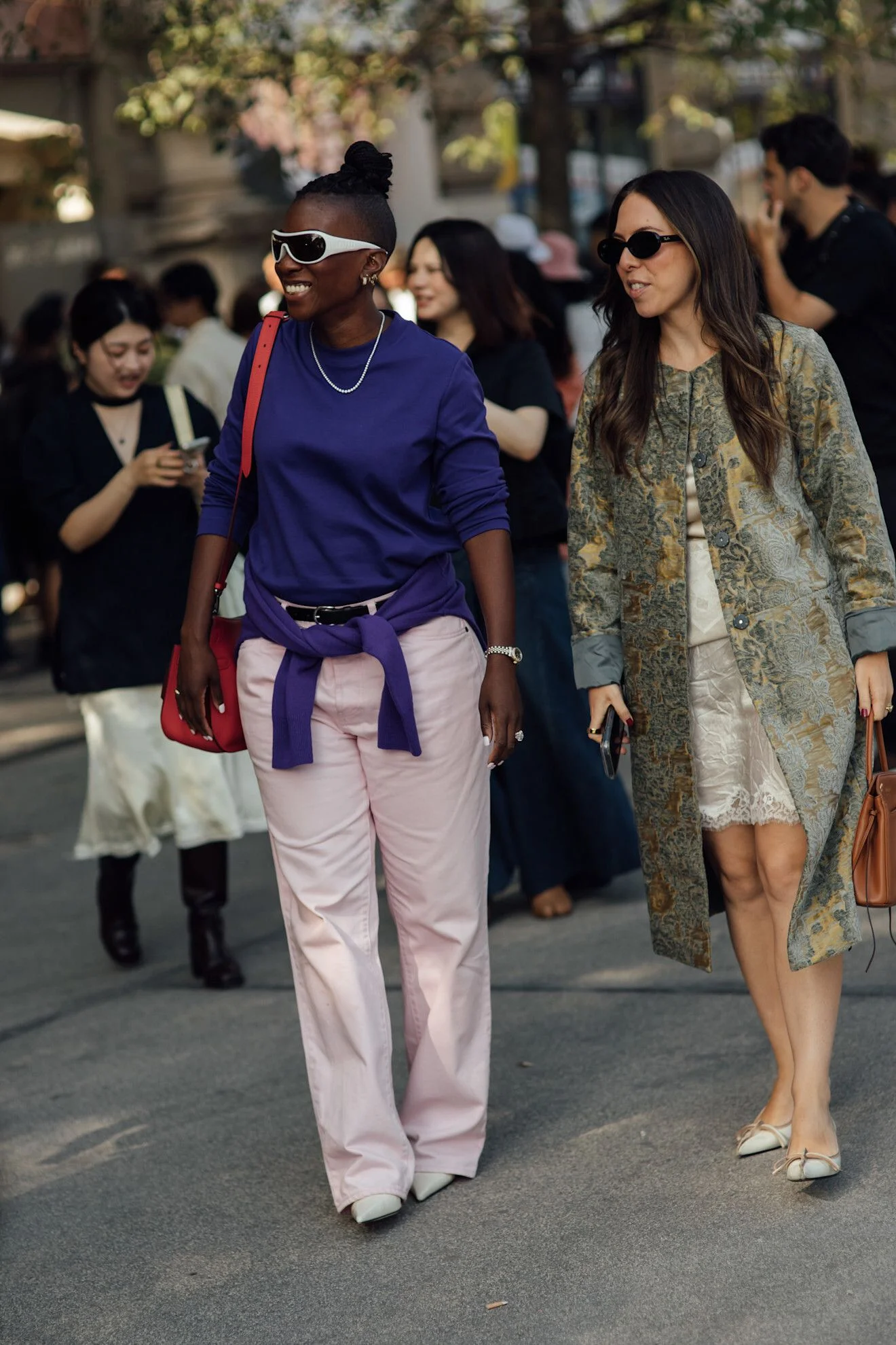 Image may contain Heather Small Pedestrian Person Adult Clothing Coat Accessories Bag Handbag Jewelry and Necklace