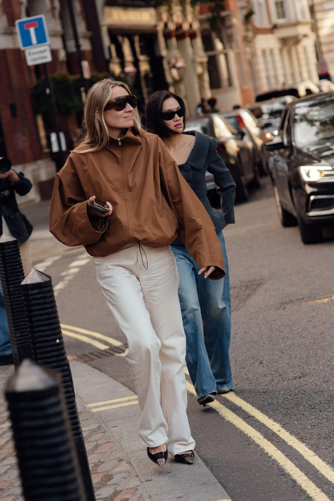 Image may contain Wendi Murdoch Clothing Pants Pedestrian Person Hoodie Knitwear Sweater Sweatshirt Adult and Coat