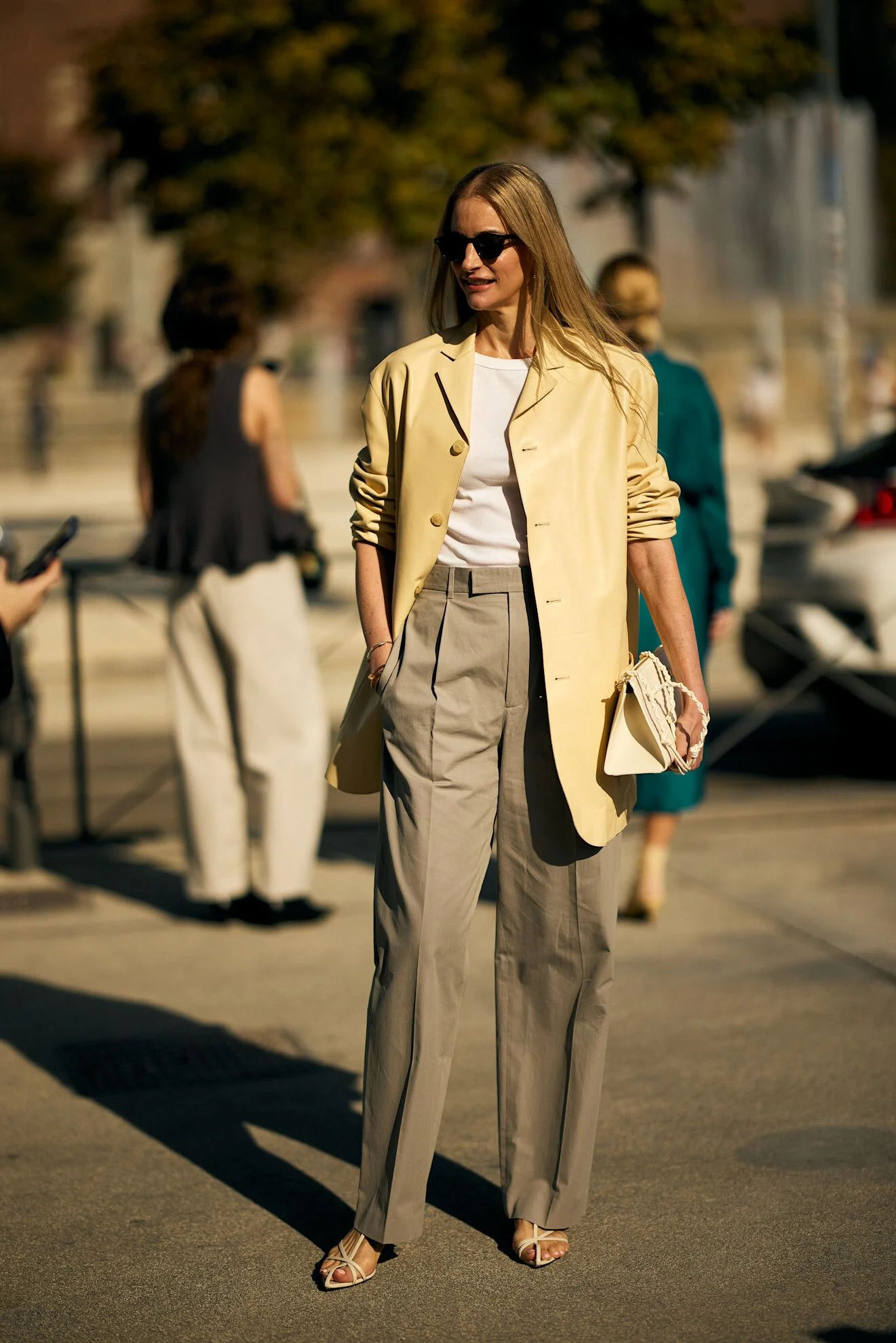 Image may contain Maylada Susri Person Walking Blazer Clothing Coat Jacket Pants Accessories Bag and Handbag