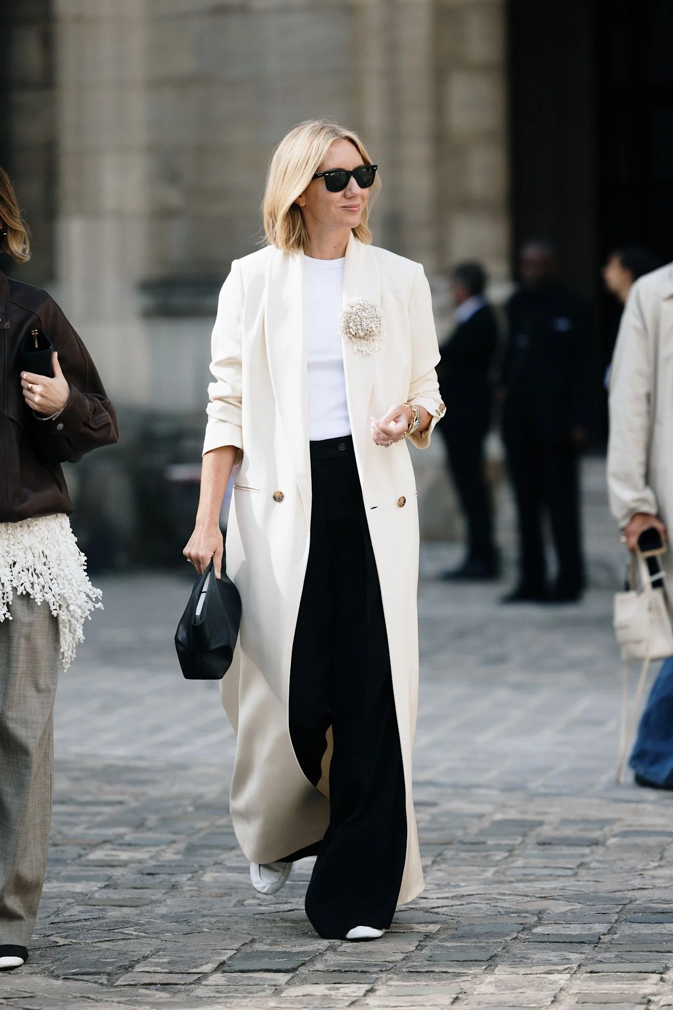 Image may contain Person Clothing Coat Accessories Bag Handbag Overcoat Adult and Wedding