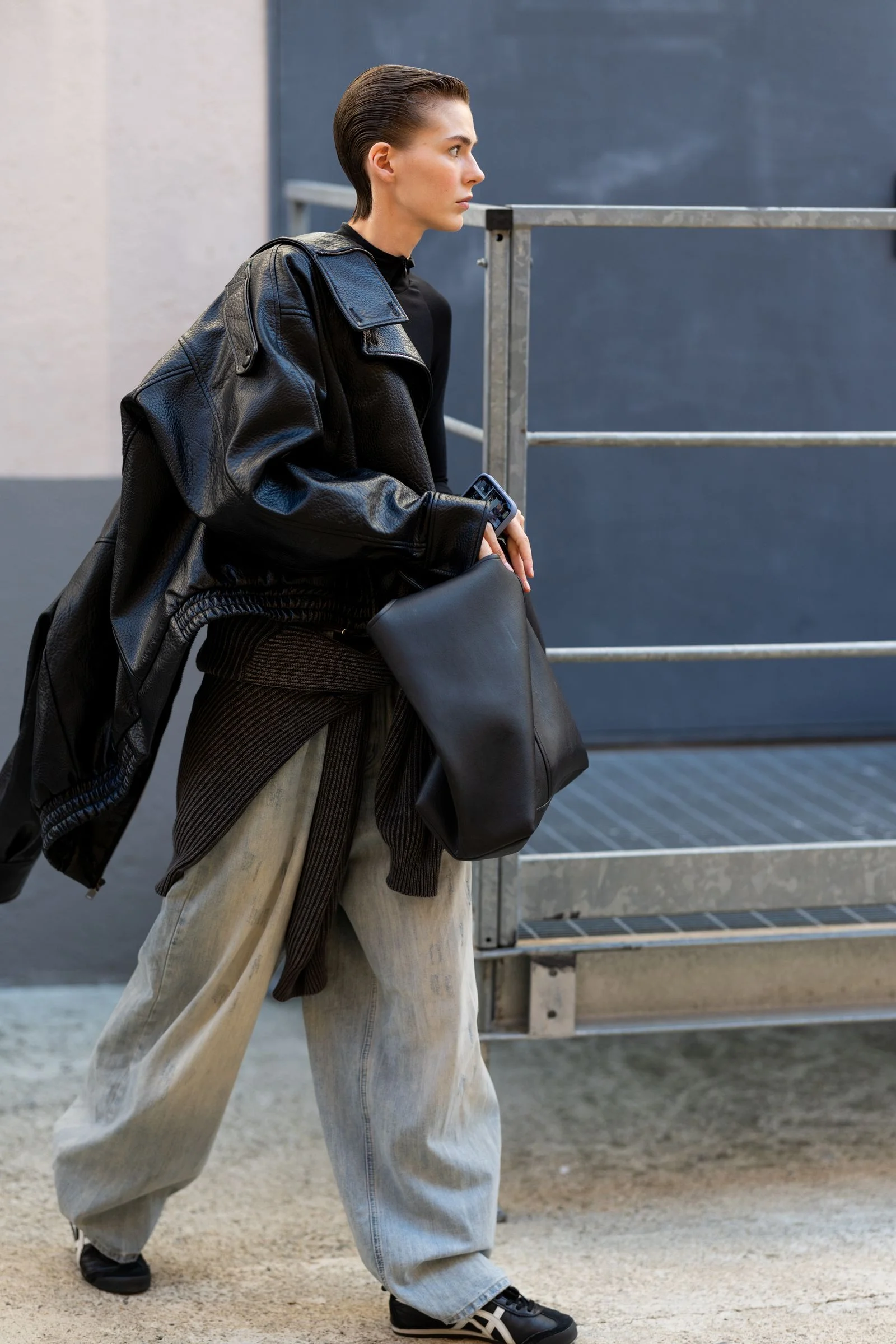 Image may contain Clothing Coat Jacket Accessories Bag Handbag Pants Adult Person Fashion and Purse