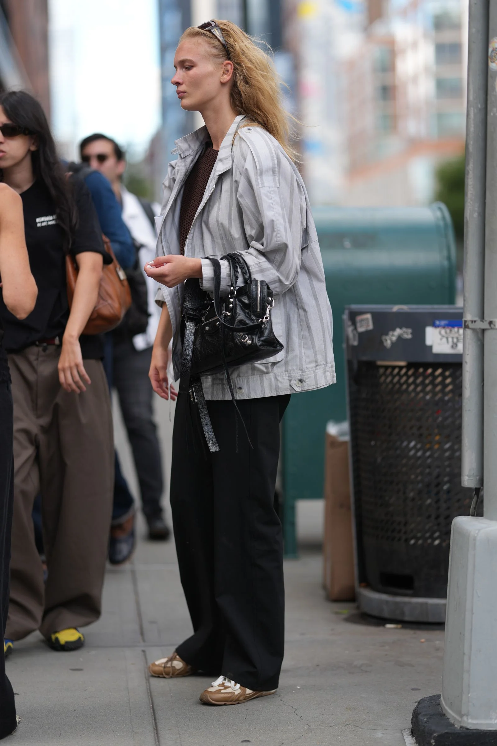 Image may contain Accessories Bag Handbag Adult Person Formal Wear Clothing Suit Coat Purse Pedestrian and Face