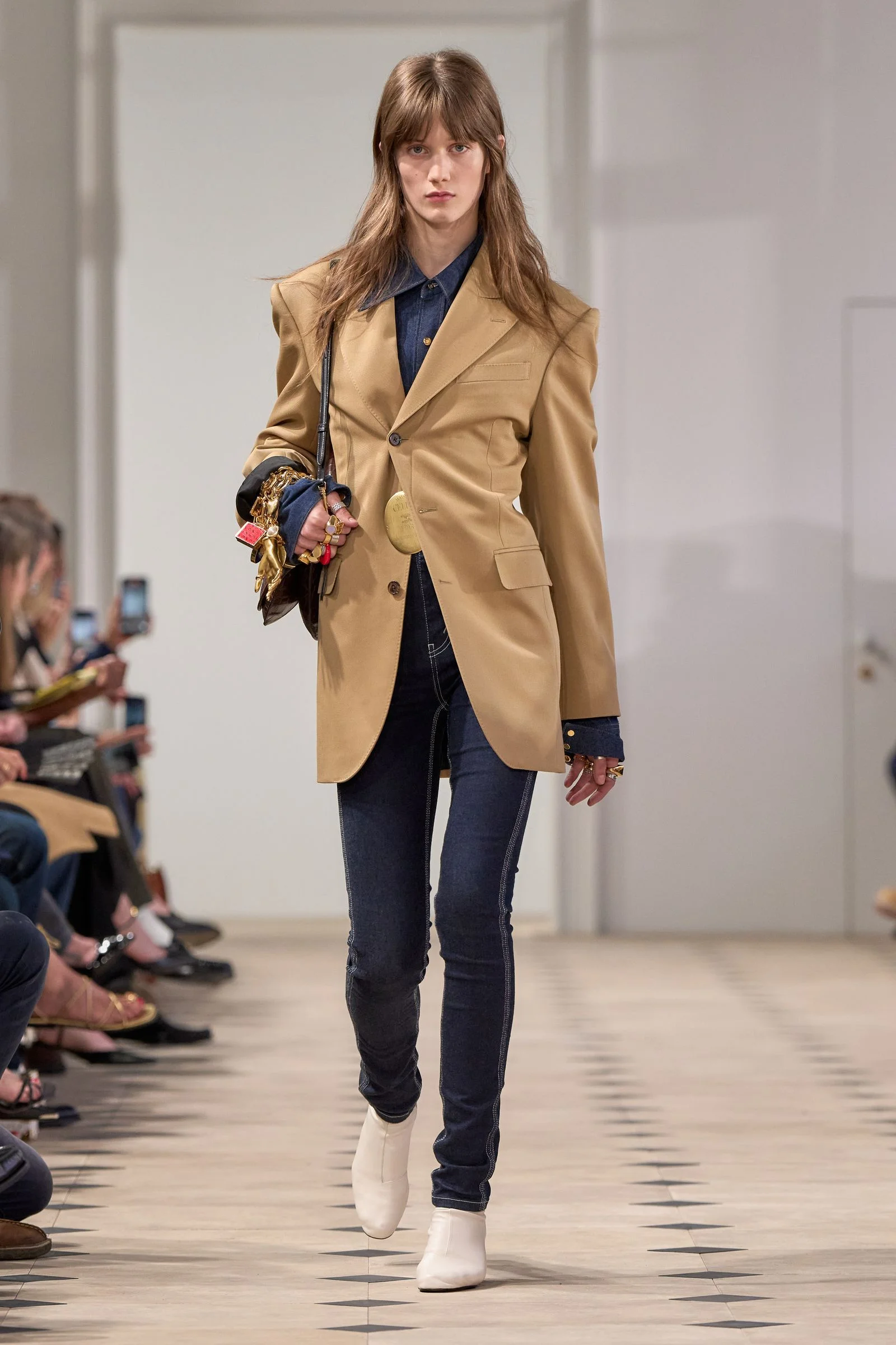 Image may contain Clothing Coat Pants Blazer Jacket Adult Person Footwear Shoe Electronics Mobile Phone and Phone