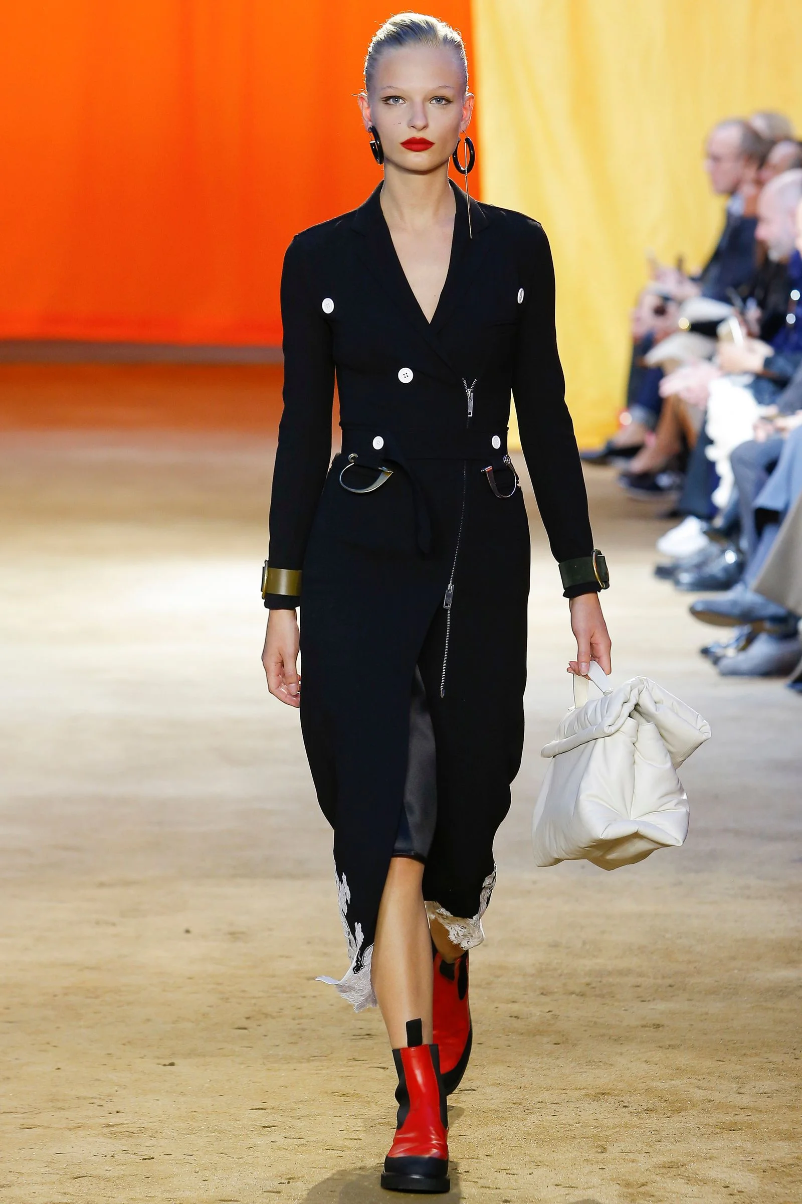 This image may contain Clothing Apparel Coat Runway Sleeve Human Person Fashion and Overcoat