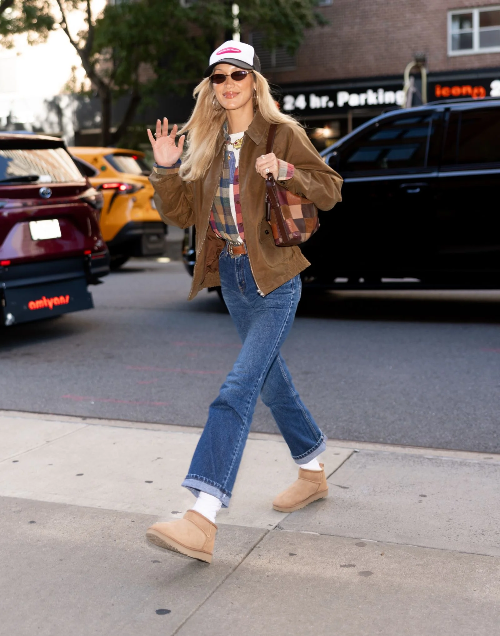 Image may contain Bella Hadid Clothing Pants Jeans Person Teen Footwear Shoe Pedestrian Coat Baseball Cap and Cap