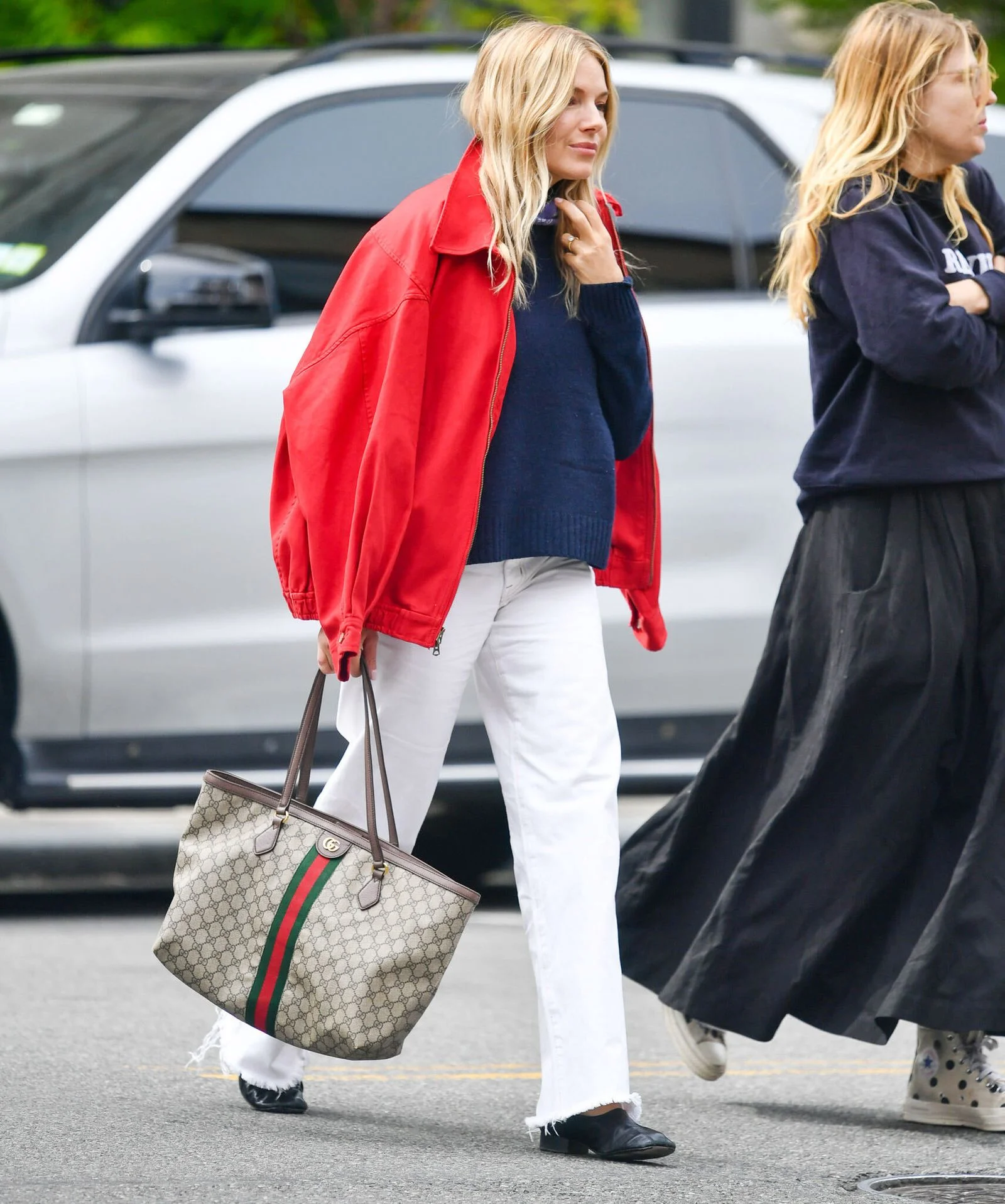 Image may contain Sienna Miller Person Walking Clothing Coat Pants Accessories Bag Handbag Adult and Pedestrian