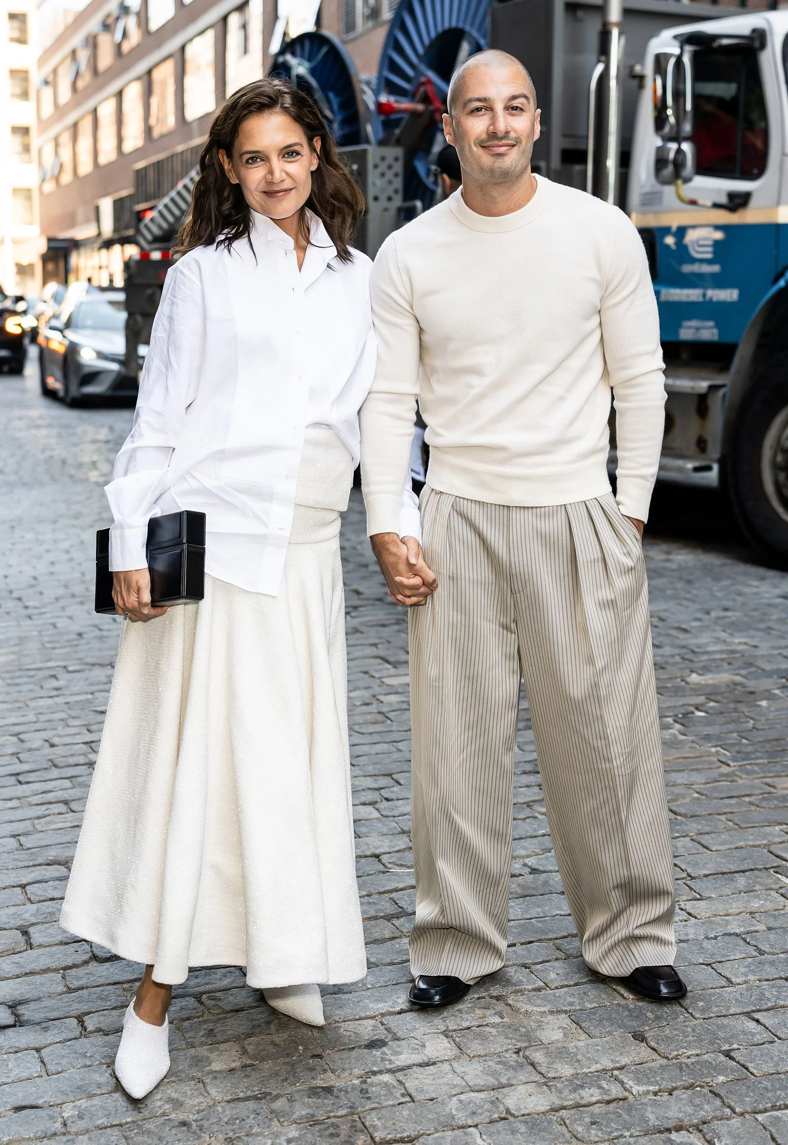 Image may contain Fabri Fibra Katie Holmes Body Part Hand Person Holding Hands Adult People Car and Transportation