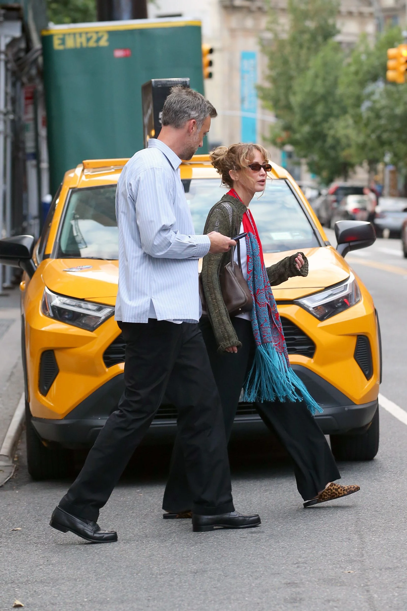Image may contain Jennifer Lawrence Pedestrian Person Adult Clothing Coat Footwear Shoe Car and Transportation