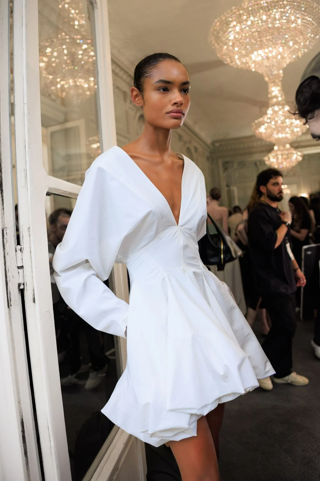 Image may contain Anais Mali Chandelier Lamp Clothing Dress Adult Person Sleeve Fashion Accessories and Bag
