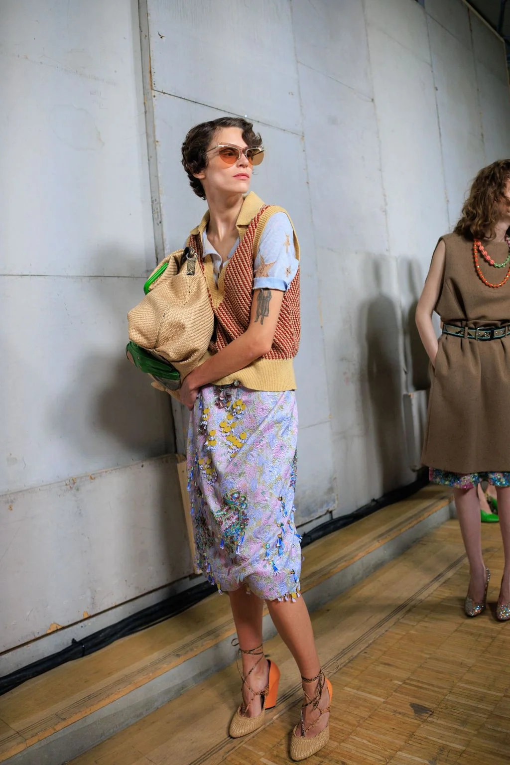Image may contain Accessories Bag Handbag Person Adult Clothing Skirt Purse Dress Footwear High Heel and Shoe