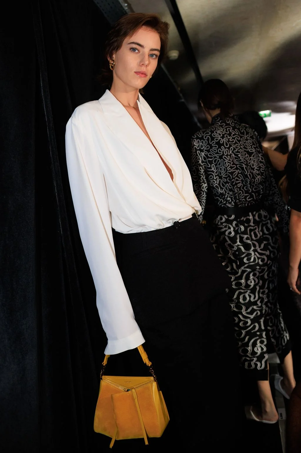 Image may contain Hannah Ferguson Blouse Clothing Long Sleeve Sleeve Fashion Formal Wear Suit Accessories and Bag
