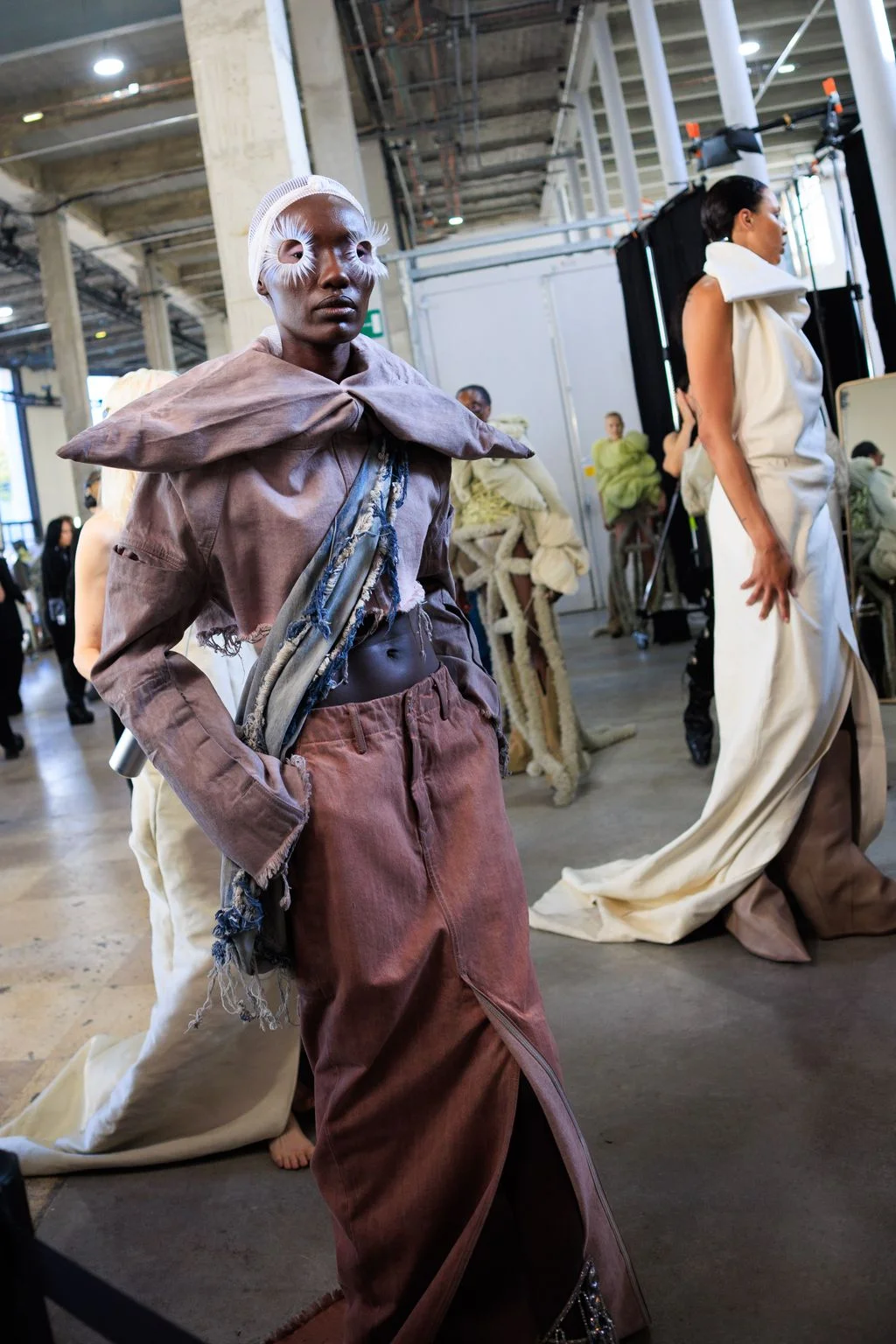 Image may contain Grace Jones Suzzanne Douglas Clothing Costume Person Adult Wedding Coat Accessories and Bag