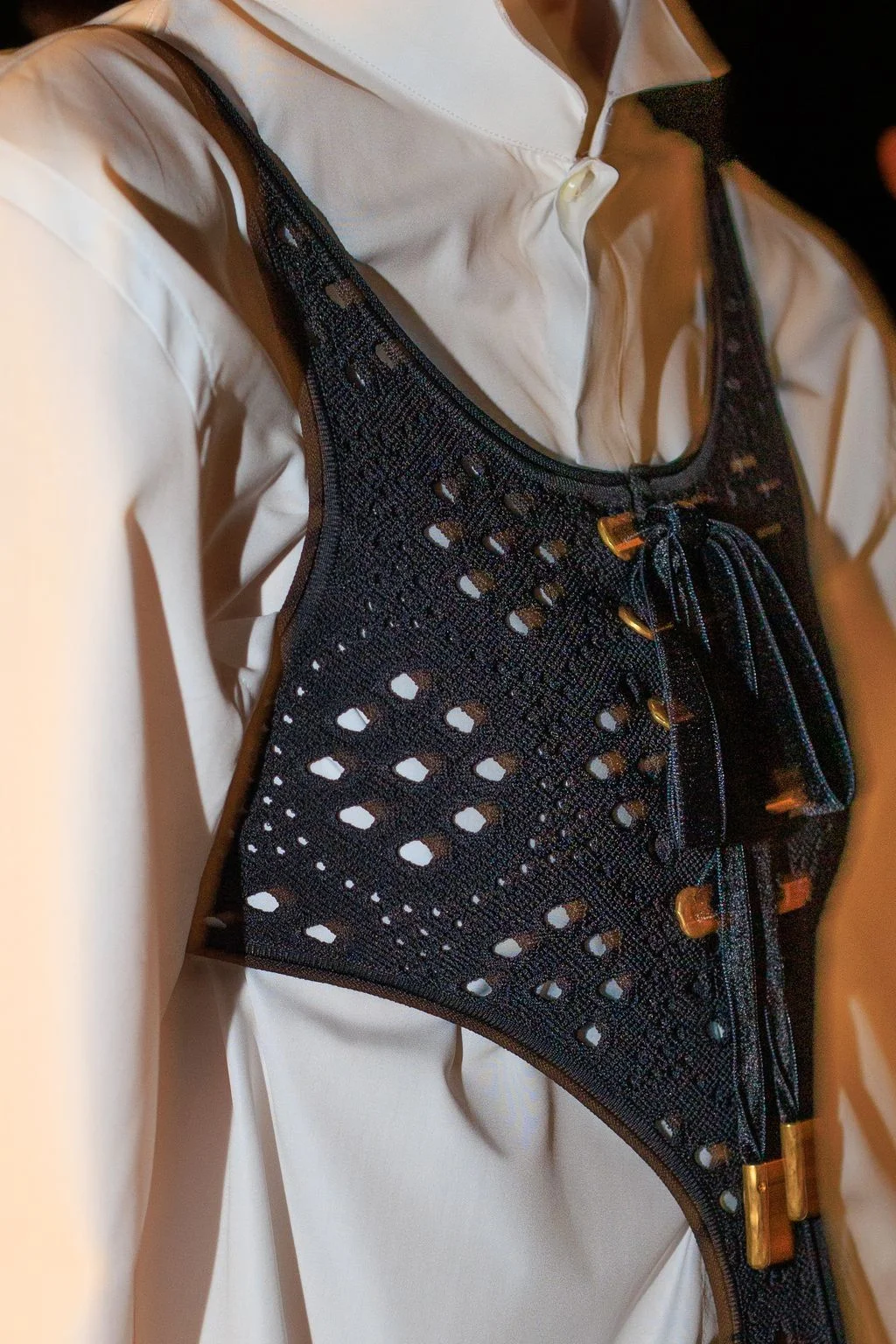 Image may contain Blouse Clothing Vest Adult and Person