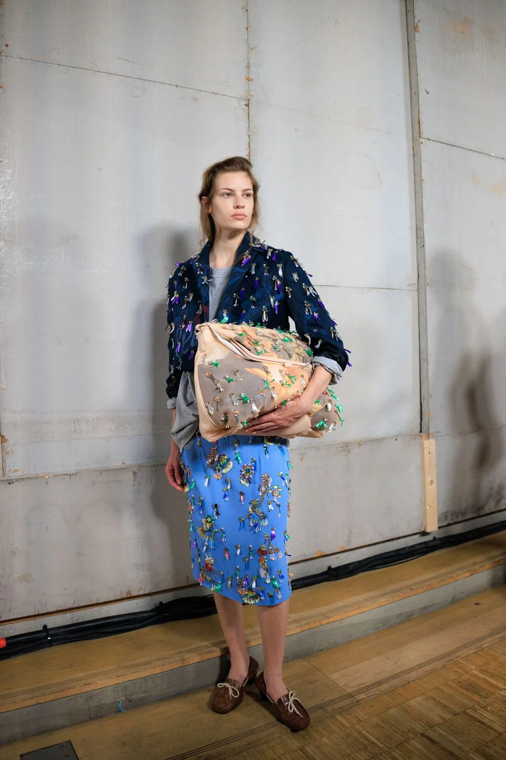 Image may contain Adult Person Accessories Bag Handbag Blouse Clothing Skirt Dress and Formal Wear